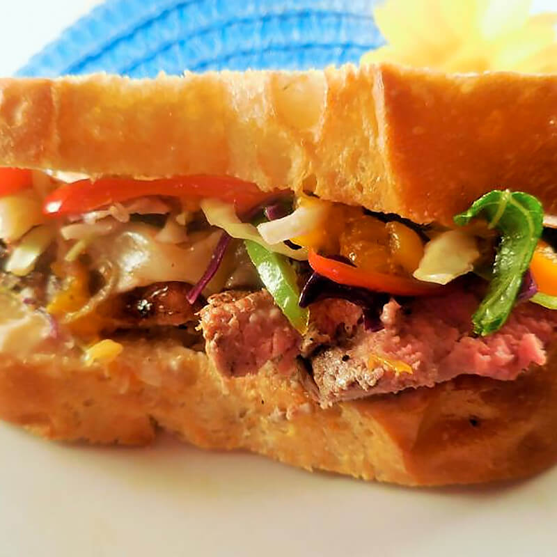 Bulgogi Pepper Ribeye Sandwich with Citrus Cabbage Mandarin Mango Slaw