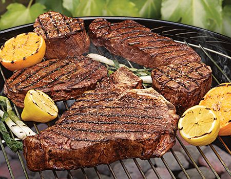 Sear steaks on charcoal grill.